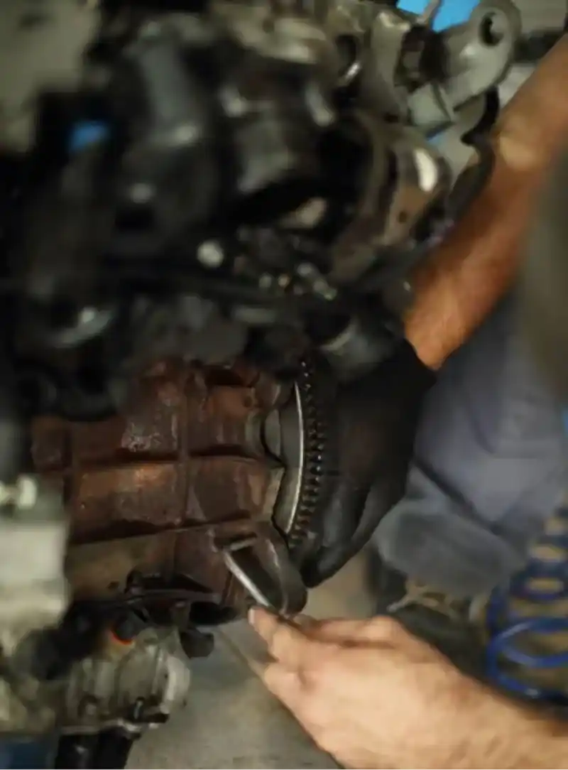 diesel-clutch-replacement-flywheel-pressure-plate-fleetway-clinton-ut. Mechanic performing diesel clutch replacement and flywheel service on a work truck engine at Fleetway Services and Repair in Clinton, UT.